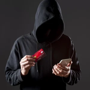 front-view-male-hacker-holding-smartphone-credit-card-3920828295.jpg